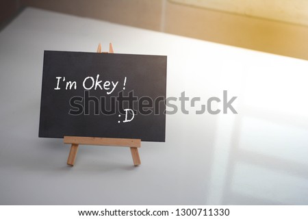 Motivational concept- "I'm Okey! :)" on the small blackboard.