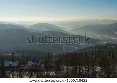 Winter scenery in Silesian Beskids mountains. View from Rownica, Ustron. View from above. Landscape photo captured with drone. Poland, Europe. 