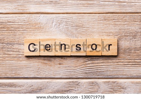 Censor word written on wood block. Censor text on wooden table for your desing, concept.