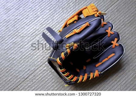 Baseball glove with floor background