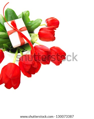 Picture of red tulips flowers and small white gift box on fresh green leaves, romantic still life for happy mothers day isolated on white background, festive border, birthday holiday, cute surprise