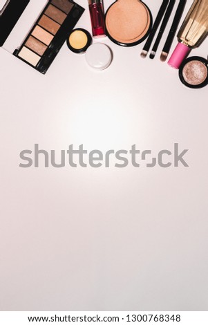 Set of cosmetics, makeup tools and accessories on a white background with copy space for text. View from above.