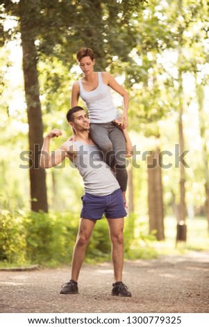 Young beautiful couple doing exercises outdoors