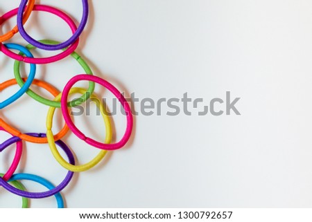 Colourful elastic hair bands isolated on a white surface.