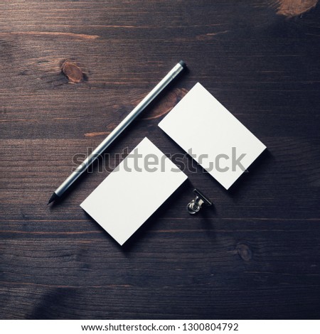 Photo of blank business cards and pencil on wood table background. Flat lay.