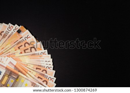 Euro money banknotes on dark background.