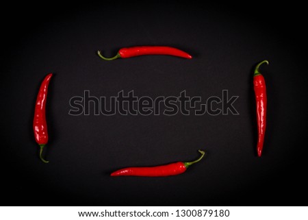 Red hot chilli peppers on dark background.