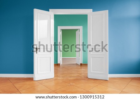 open doors in empty apartment with colored walls  Royalty-Free Stock Photo #1300915312