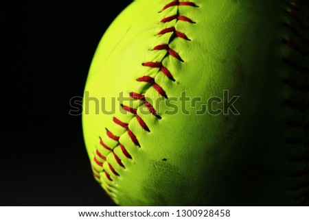 Bright softball on black background.