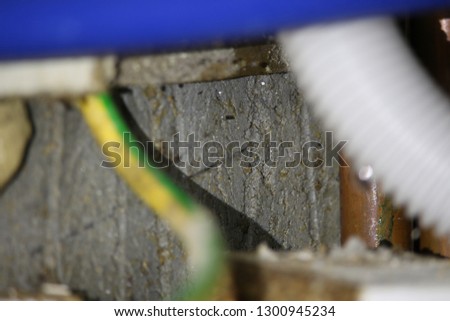 Wires at the back of a cupboard underneath the sink