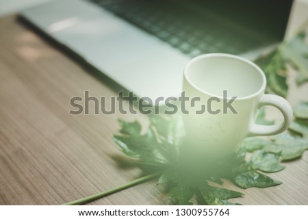 Laptop on a wooden table and a cup of coffee - Images.