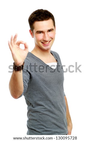 A handsome man shows a sign okay isolated on white background