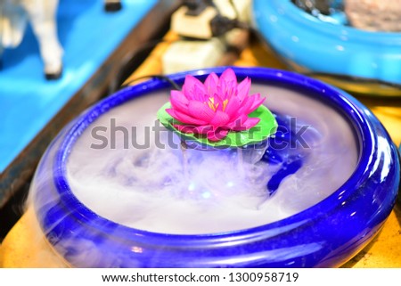 Lotus floating in the water, then there is smoke. Is the faith of Thailand . 