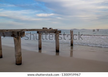 Abandoned pier on a quiet beach near Esperance in western Australia taken just after sundown for moody lighting