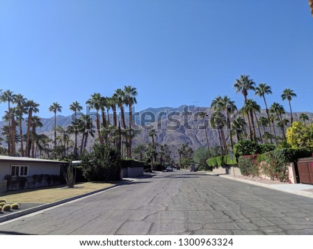 Cracked Empty Road in Taquitz Canyon River Estates, Palm Springs, California with mountains in the distance