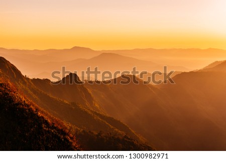 Dramatic sunset sky and light and shadow of trees on the mountain, Morning light is colorful and beautiful in nature, Landscape photography of the scenery view in northern Thailand