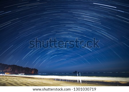 star trail at the beach with figure