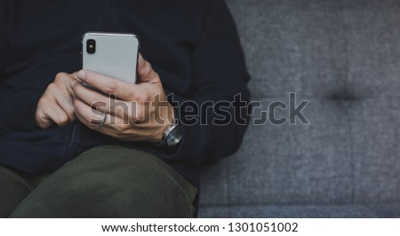 Businessman at workplace Think business investment plan.Contact Investor using cell phone,computer make note meeting of appointment information in the notebook.design creative work space
