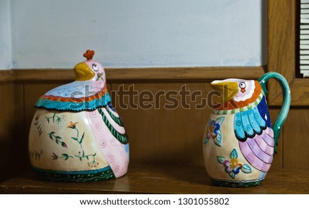 Antique ceramic pitchers on wooden table. Vintage interior.