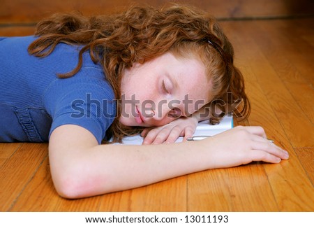 a young female child laying down sleeping on her diary or journal