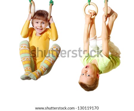 preschool children playing and exercising on gymnastic rings