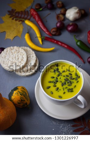 Pumpkin asian coconat cream soup. Autumn hot food. chili pepper, garlic, red onion, big pumpkin. Dark pgoto