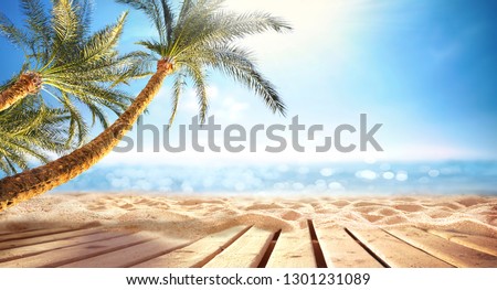 Summer  panoramic  landscape, nature of tropical beach with wooden platform, sunlight. Golden sand beach, palm trees, sea water against blue sky with white clouds. Copy space, summer vacation concept.