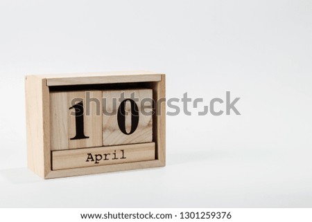 Wooden calendar April 10 on a white background close up