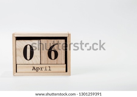 Wooden calendar April 06 on a white background close up
