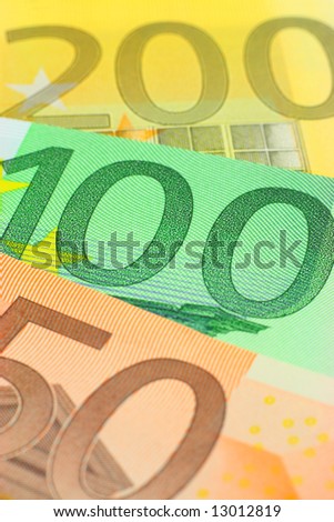 Three euro notes closeup. Shallow depth of field, focus on 100 note.