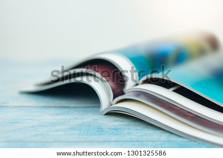 Stack magazines on wooden table Royalty-Free Stock Photo #1301325586