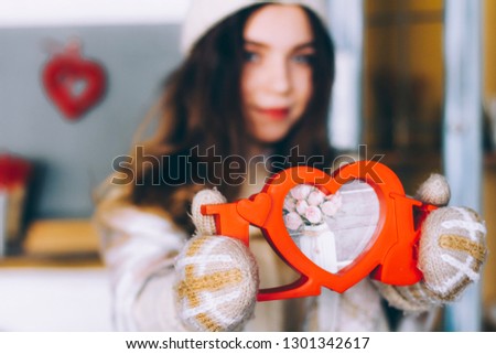 Red letters love close up. A girl holds in her hands the word love wooden picture frame