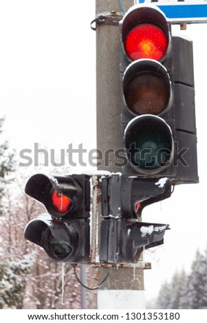 Frozen traffic light with snow, Russia