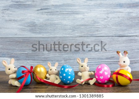 Easter eggs cute bunny. Funny decoration. Cute creative photo. Colorful easter eggs and rabbit.