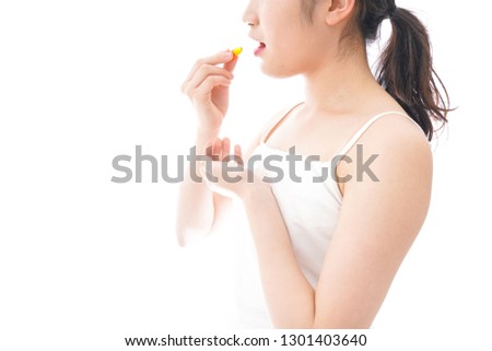 Young woman taking medicine