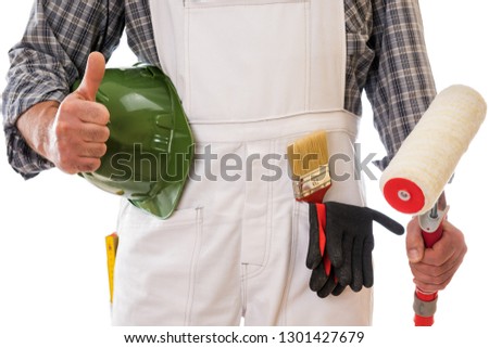 House painter worker in white work overalls with thumb up, holds in his hand the roller to paint. Equipped with protective gloves. Isolated on white background. Construction industry.