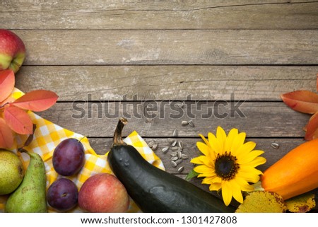 Autumn background with fruits and sunflowers. Copy space. Top view