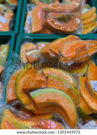 Slices of fresh pumpkin in market of Turkey, close up or focus.Background of pumpkin's slices.Bar code on the plastic wrap