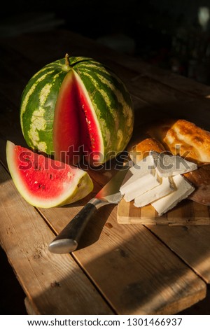 Delicious white cheese, warm tandir bread and juicy watermelons - the harmony between these 3 elements makes for a uniquely Azerbaijani summer treat Royalty-Free Stock Photo #1301466937