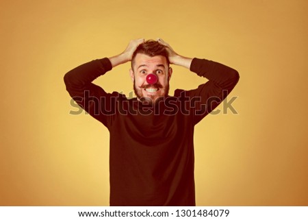 The happy surprised and smiling man on red nose day  or april fools day. The clown, fun, party, celebration, funny, joy, holiday, humor concept