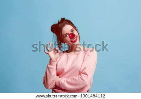 The happy surprised and smiling woman on red nose day. The clown, fun, party, celebration, funny, joy, holiday, humor concept