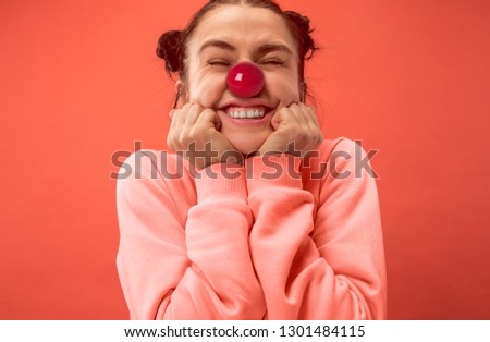 The happy surprised and smiling woman on red nose day. The clown, fun, party, celebration, funny, joy, holiday, humor concept