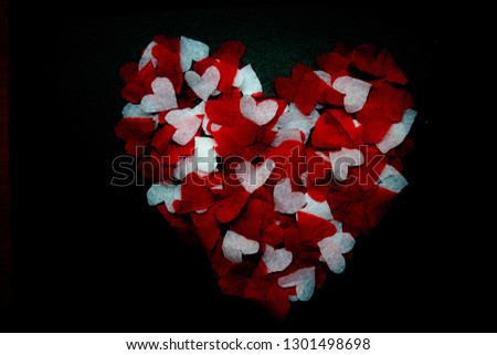 heart in the dark laid out of paper cut hearts