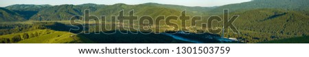 Beautiful and original panorama. Beautiful and majestic landscape and panorama of the mountain and wild river against the background of mountains, forests and sky clean.