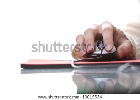 Woman hand on a mouse isolated on white with reflection and copy space (selective ans soft focus)