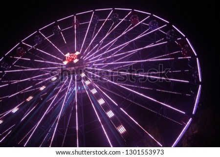 Ferris wheel at the amusement park, night illumination.