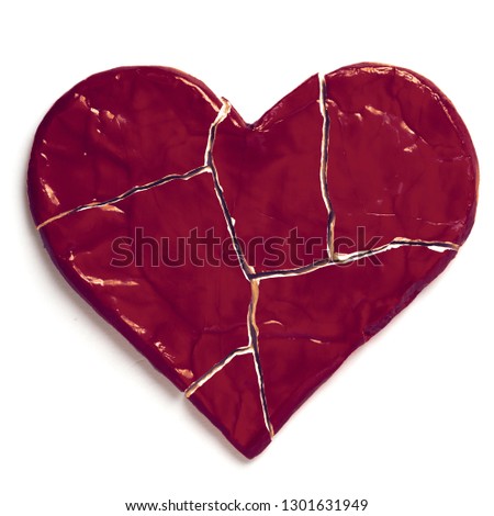 Red broken heart isolated on white background.