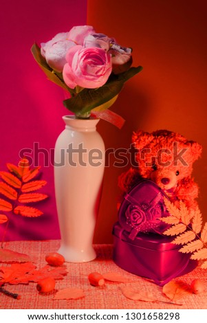 Festive still life with a vase of flowers boxes Valentine in the form of a heart bear young peonies