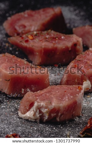 Raw pork medalions meat. Fresh steaks on black background. 45 degree