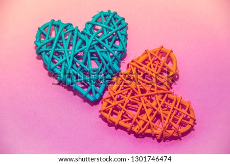 Heart of rattan on a pink background. Valentine's Day. Holiday decoration.